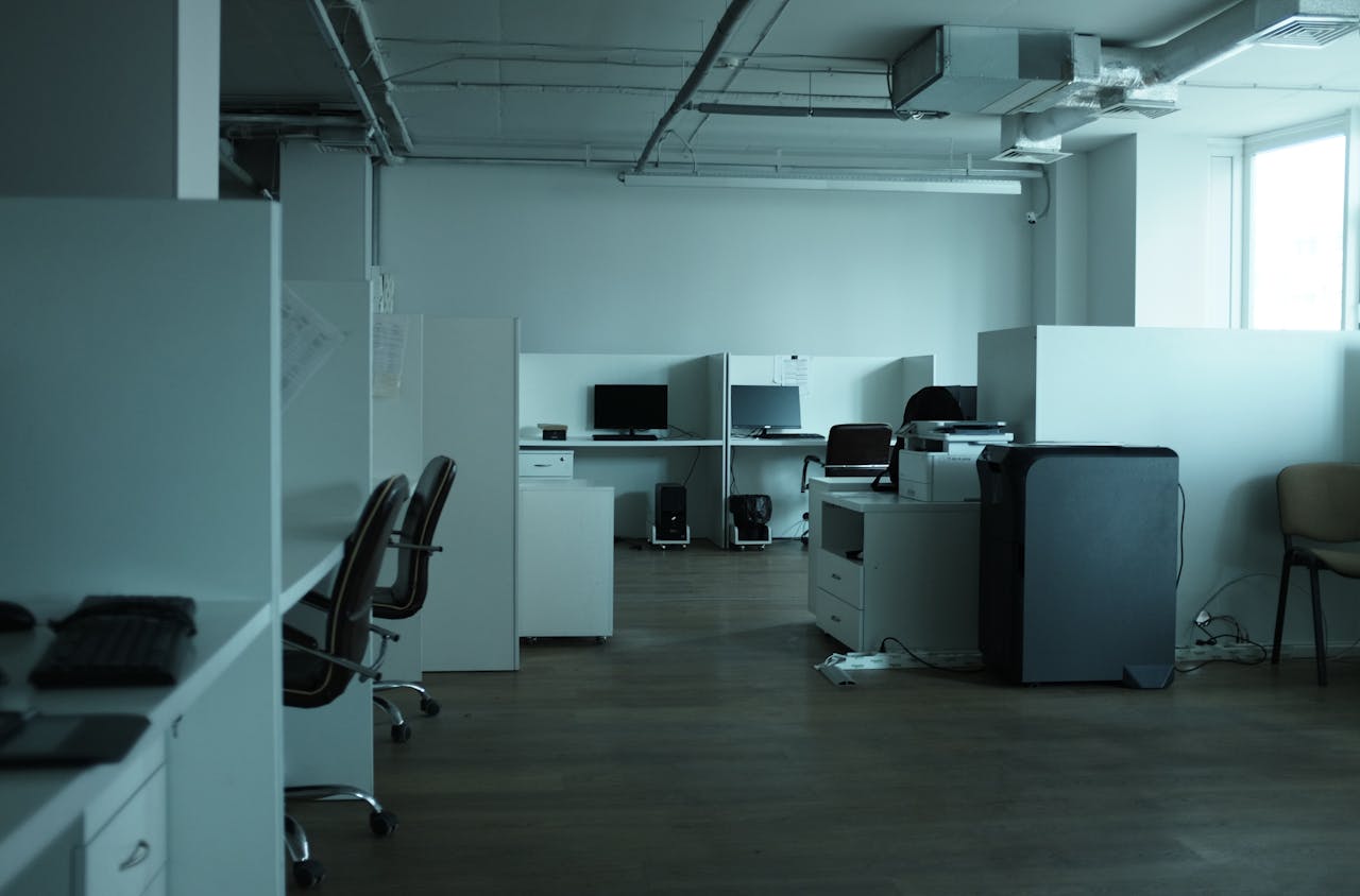 about-bg An empty modern office space in Kyiv featuring workstations, chairs, and technology.
