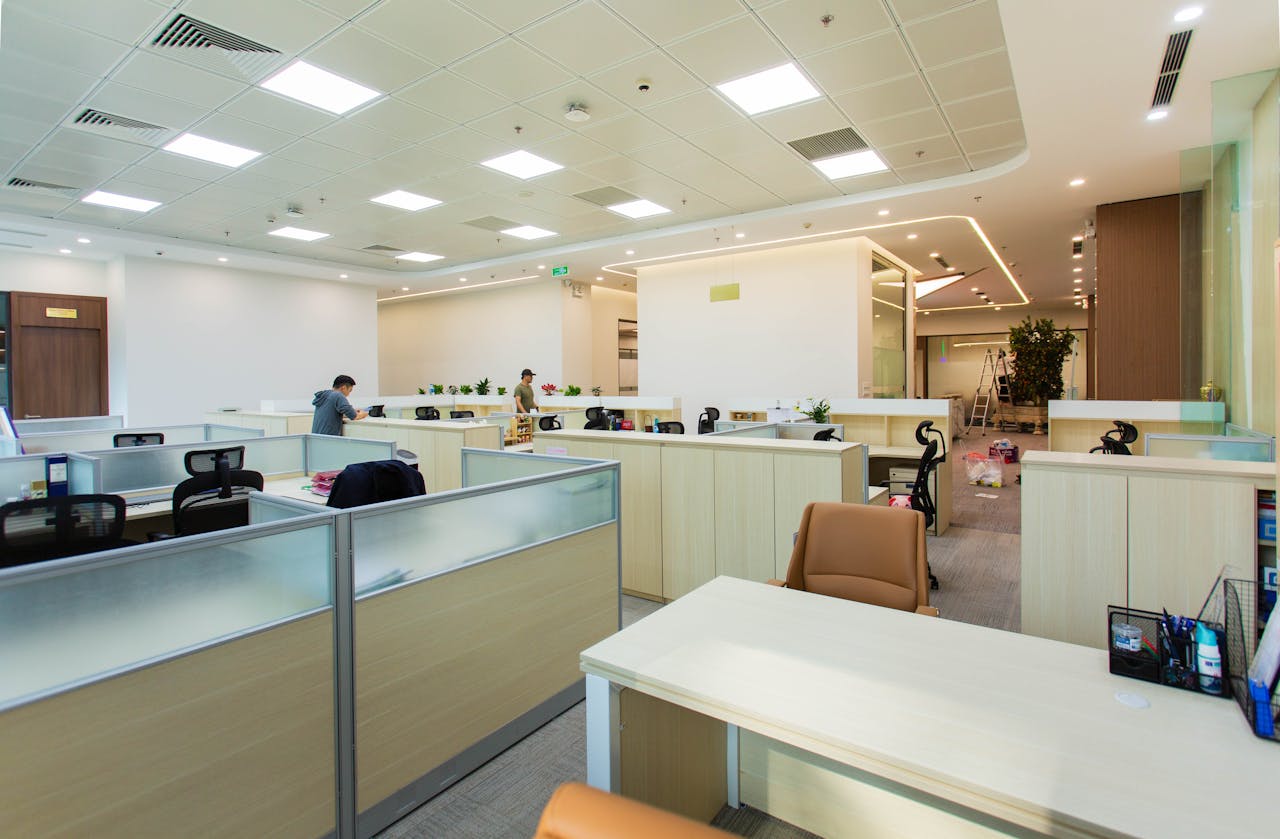 home-hero Bright and spacious office interior featuring open-plan cubicles, modern furniture, and ceiling lights.